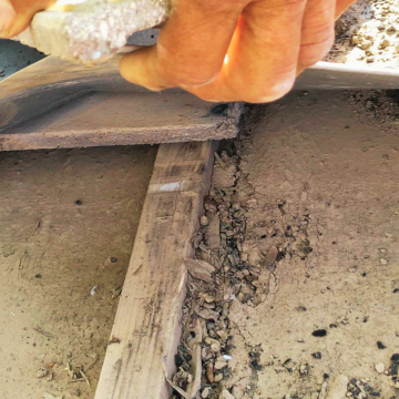 Inspection of deteriorating underlayment and debris by an emergency roof repair companies in mesa Arizona expert.