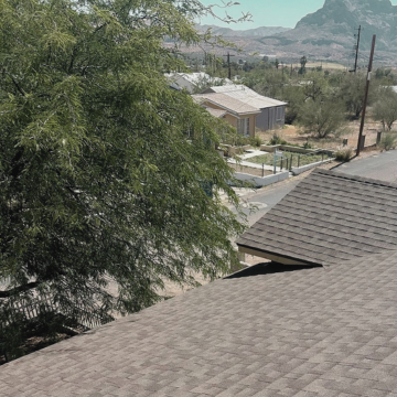 A residential asphalt shingle roof overlooking a neighborhood street, showcasing work by a professional roofing contractor chandler.