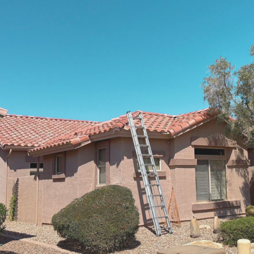 An extension ladder leaning against the side of a stucco house with a clay tile roof, ready for re roofing scottsdale az or inspection. An extension ladder leaning against the side of a stucco house with a clay tile roof, ready for re roofing scottsdale az or inspection.