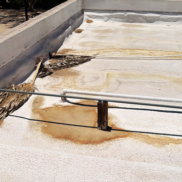 Commercial flat roof displaying severe water pooling and wear, assessed by a commercial roofing contractor mesa.