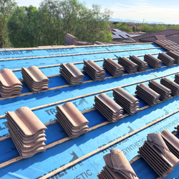 Roof deck prepped with underlayment and tiles ready for installation by a roofing contractor Gilbert AZ.
