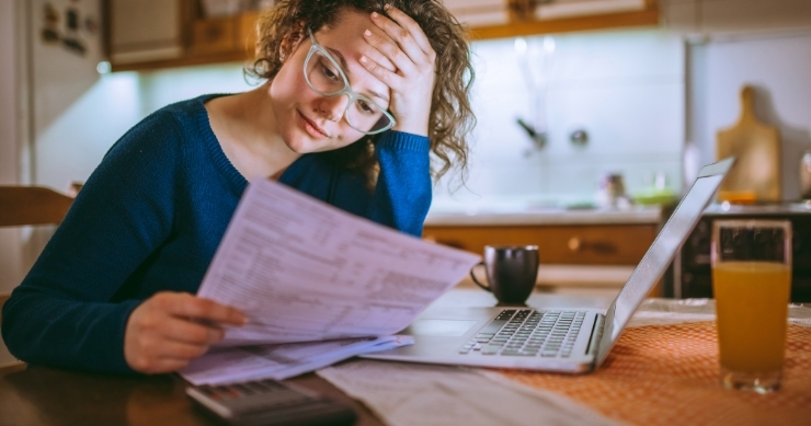 Person reviewing expensive hospital bills that may lead to medical debt and bankruptcy in the United States. Person reviewing expensive hospital bills that may lead to medical debt and bankruptcy in the United States.