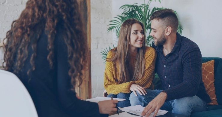 Health insurance advisor explaining total annual ACA plan costs beyond the monthly premium. Health insurance advisor explaining total annual ACA plan costs beyond the monthly premium.