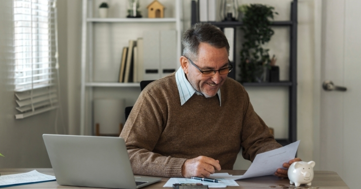 Person calculating retirement savings goals and future retirement income projections.