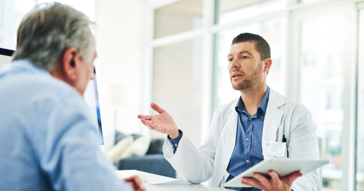 A doctor conducting a Welcome to Medicare preventive visit with a patient in a medical clinic. A doctor conducting a Welcome to Medicare preventive visit with a patient in a medical clinic.