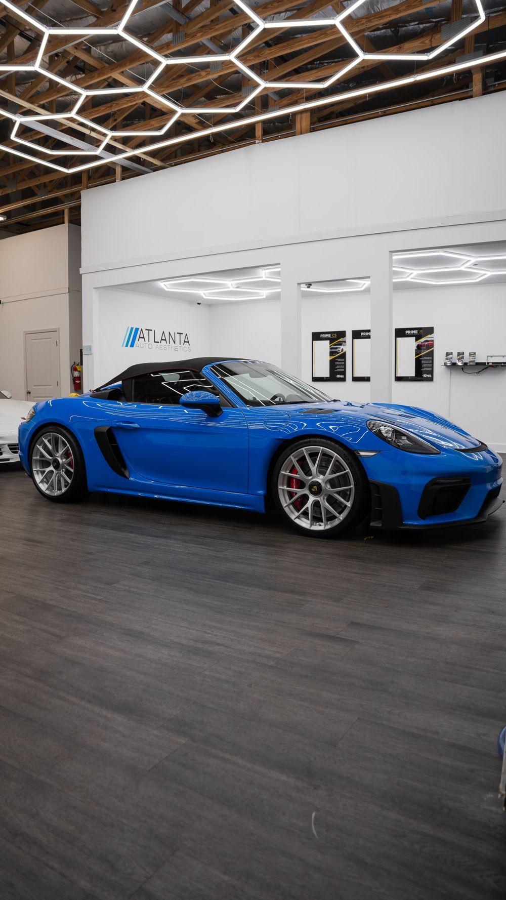Blue Porsche 718 Spyder inside the Atlanta Auto Aesthetics studio