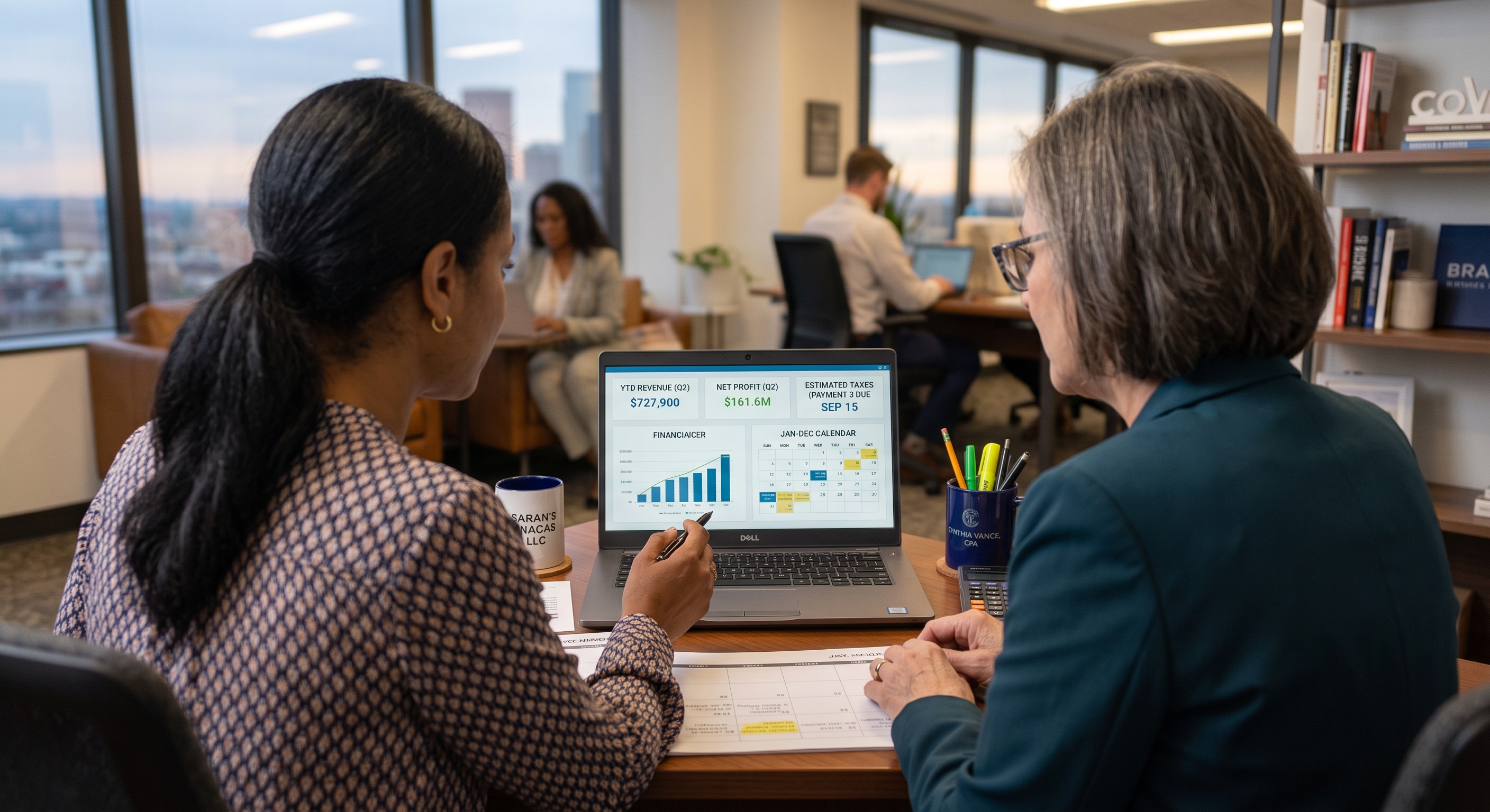 Business owner and CPA reviewing mid-year financial and tax information Business owner and CPA reviewing mid-year financial and tax information