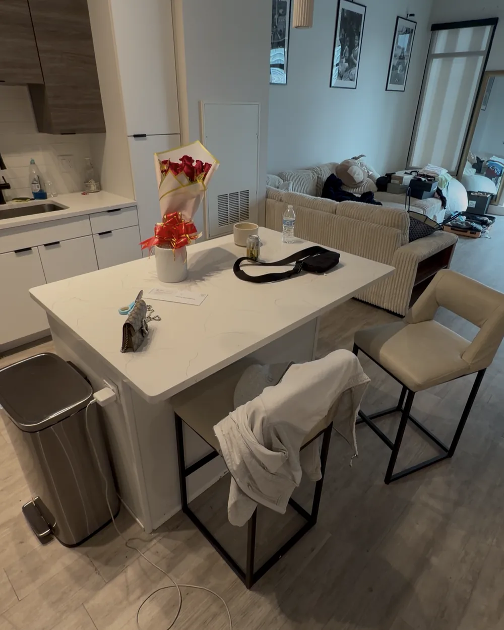 Kitchen island and counters cluttered before cleaning