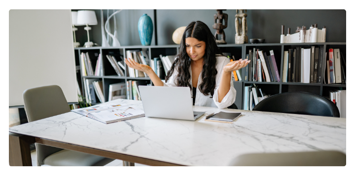 Unsure woman looking at computer
