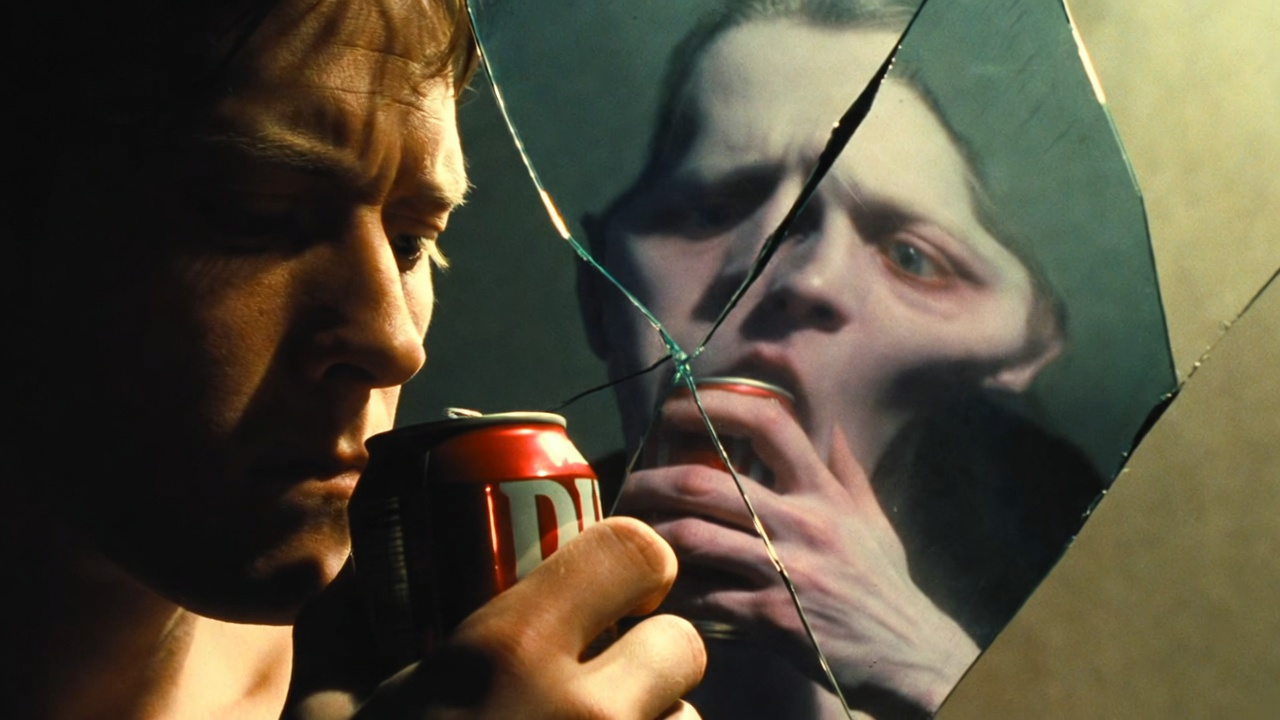 A close-up of a person holding a diet soda can, but the can is reflected in a cracked mirror showing a distorted, sickly version of the person. Split reality—healthy exterior hiding internal damage. 