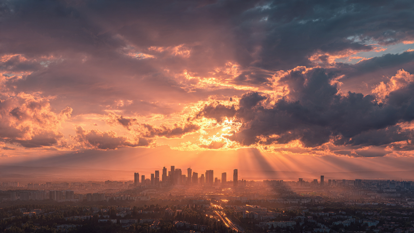 A stunning sunrise over a modern city skyline, golden hour lighting, rays of light breaking through clouds, symbolizing new beginnings and possibility, inspirational and uplifting mood, wide angle shot