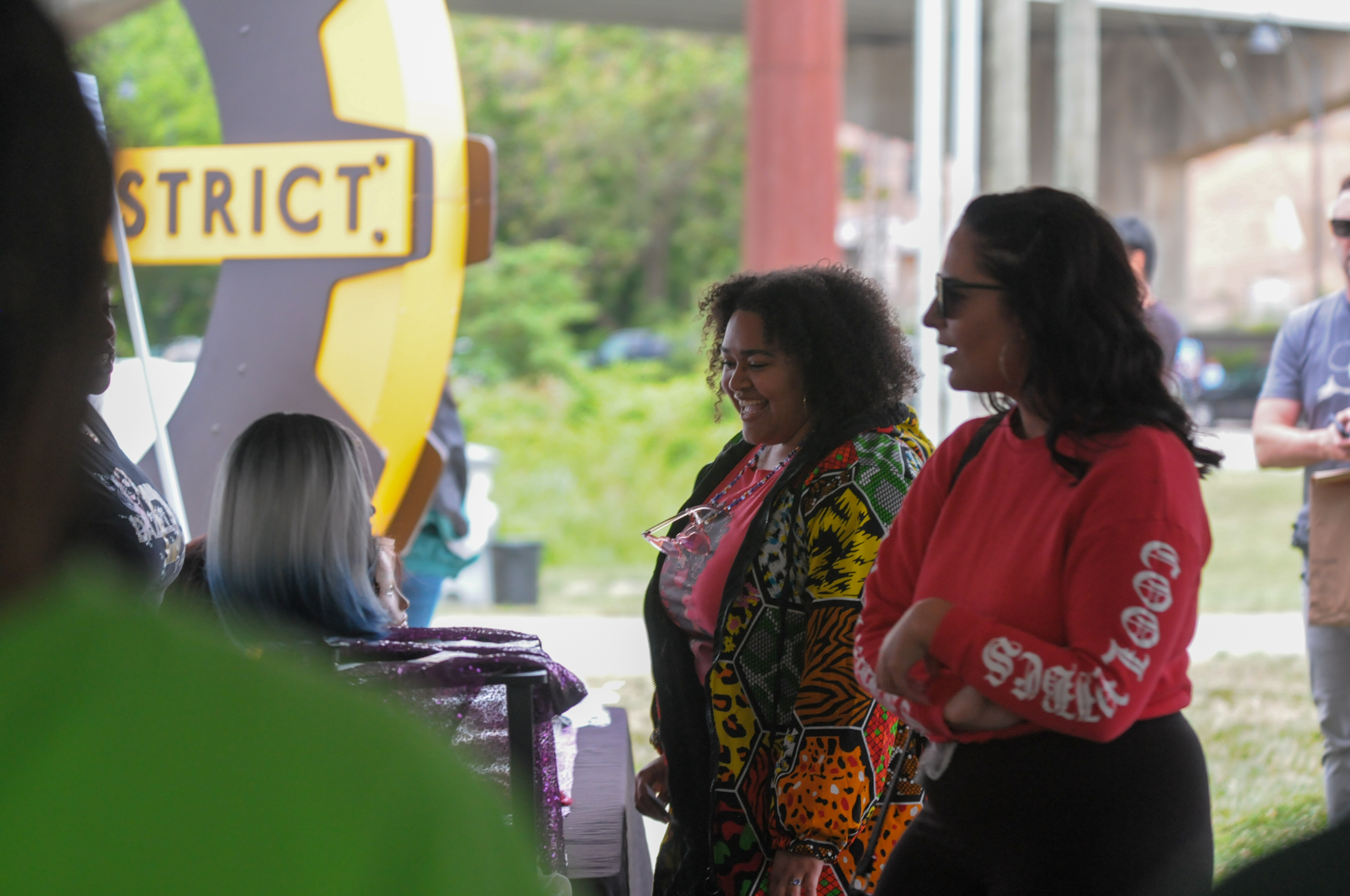 Attendees interacting inside a branded event area