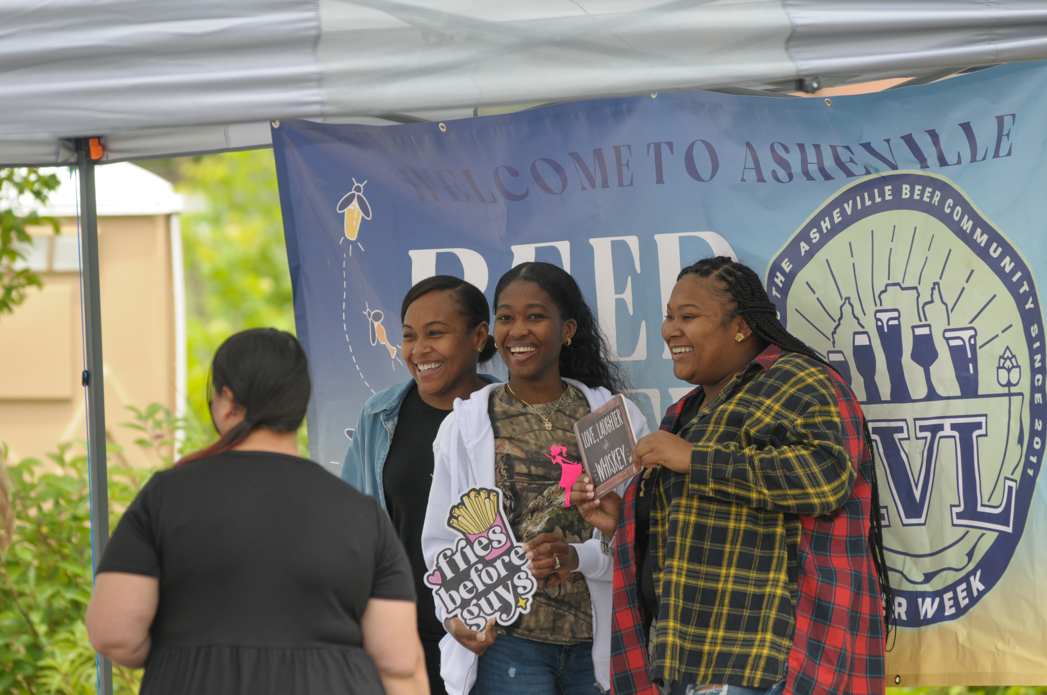 Attendees taking photos at a branded festival setup