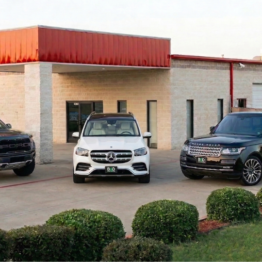 Mercedes and Range Rover in front of B&D Collision