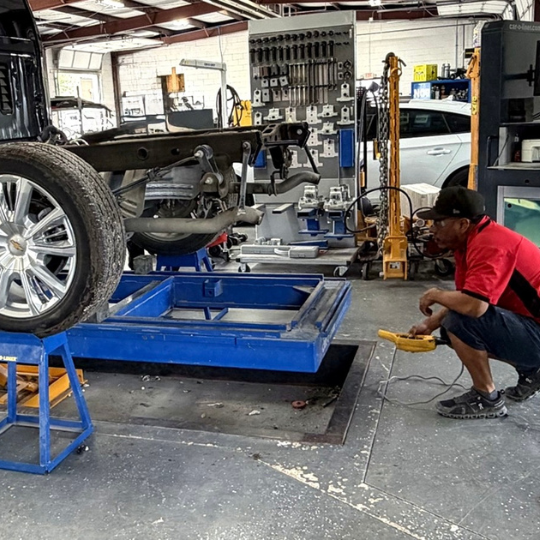 Truck on a frame straightening rack for collision repair