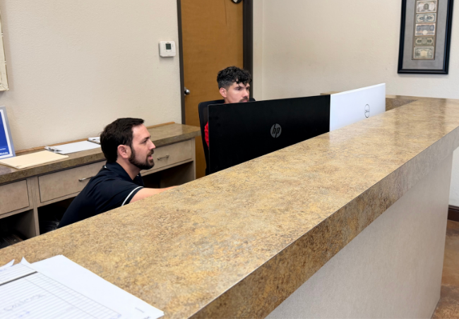 Two advisors at the front lobby desk of B&D Collision in Mesquite
