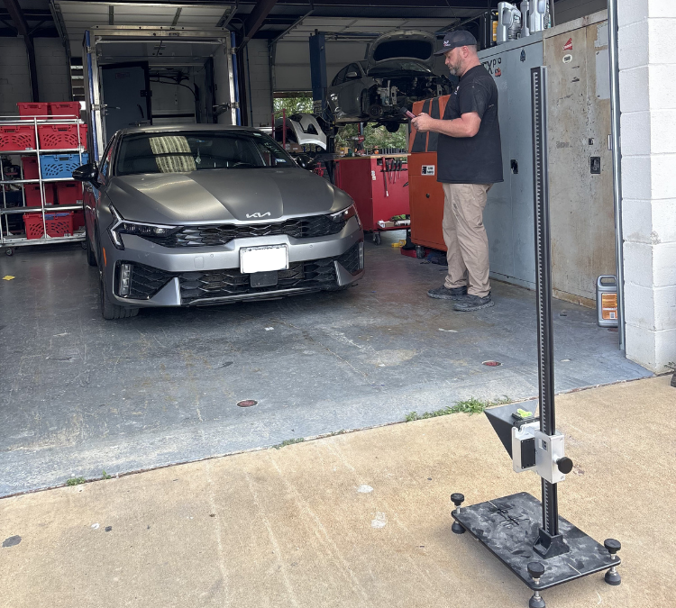A certified collision repair technician using ADAS equipment at our Mesquite location