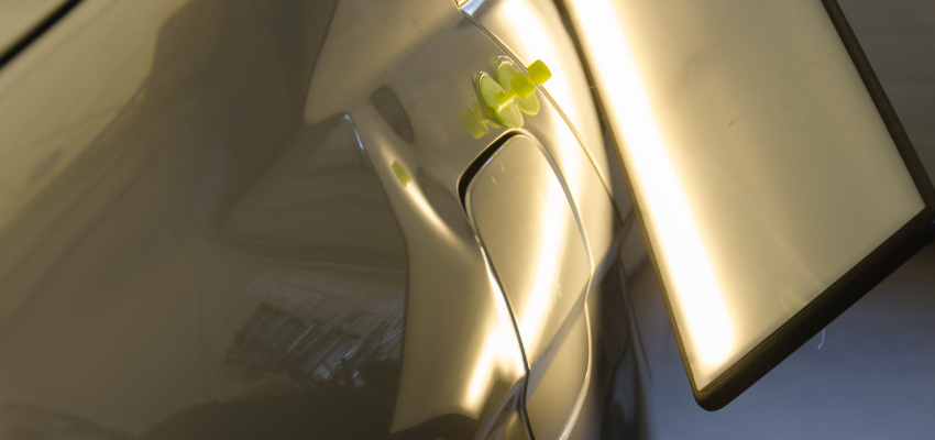 Example of a quarter panel crease dent next to fuel door on quarter panel