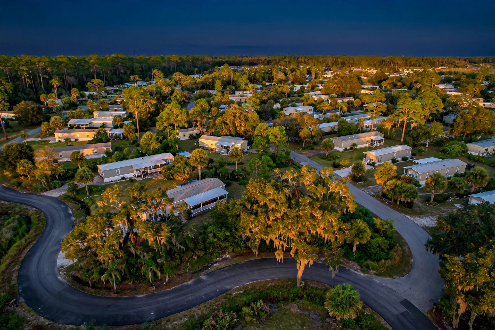 Aerial view of manufactured home community in North Florida with trees at sunset — VA manufactured home loan Jacksonville