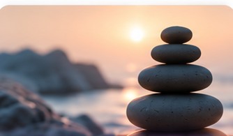Balanced stones on a beach at sunset