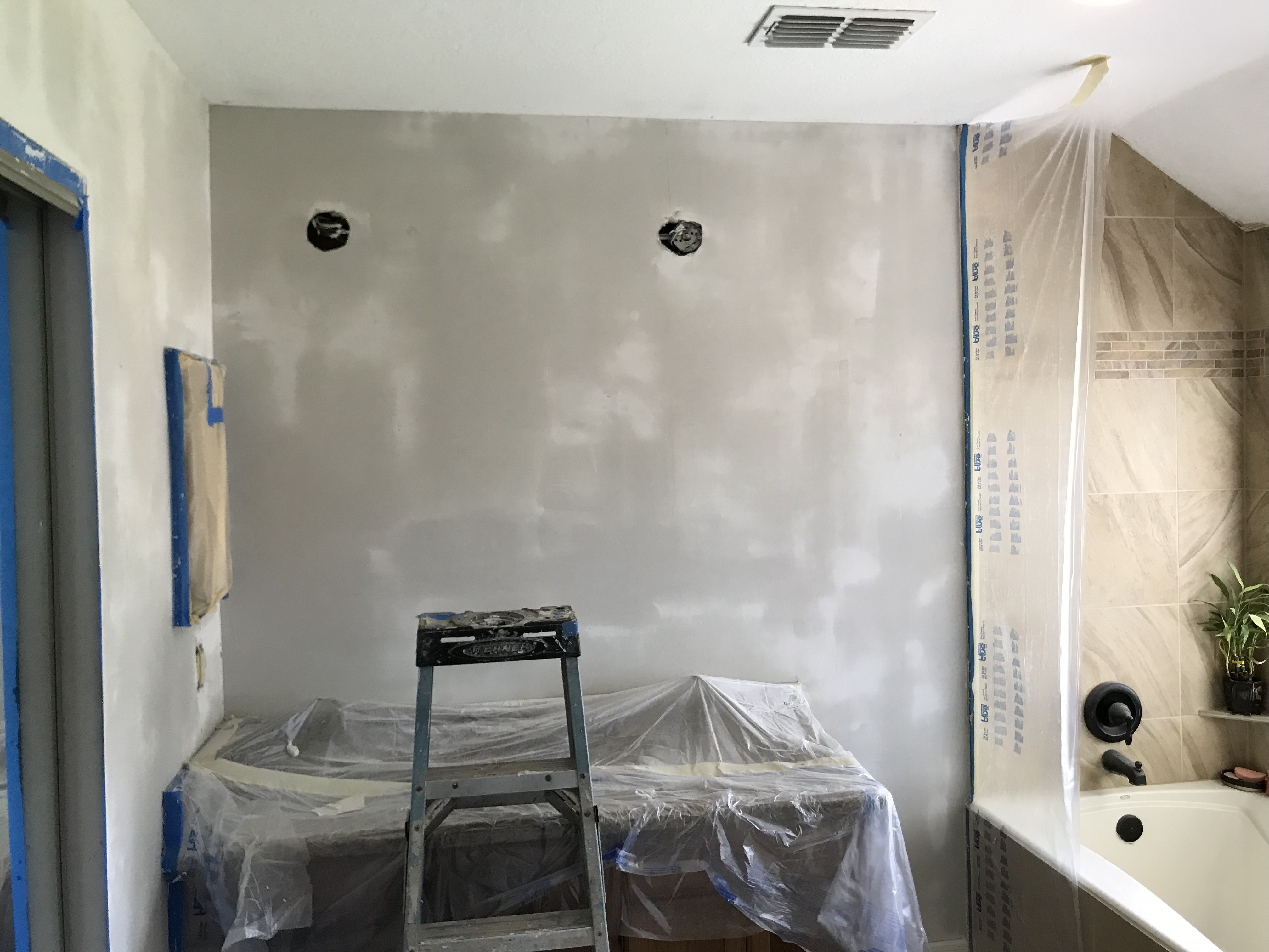 Professional contractor applying joint compound to a drywall seam in a Cypress, TX home.
