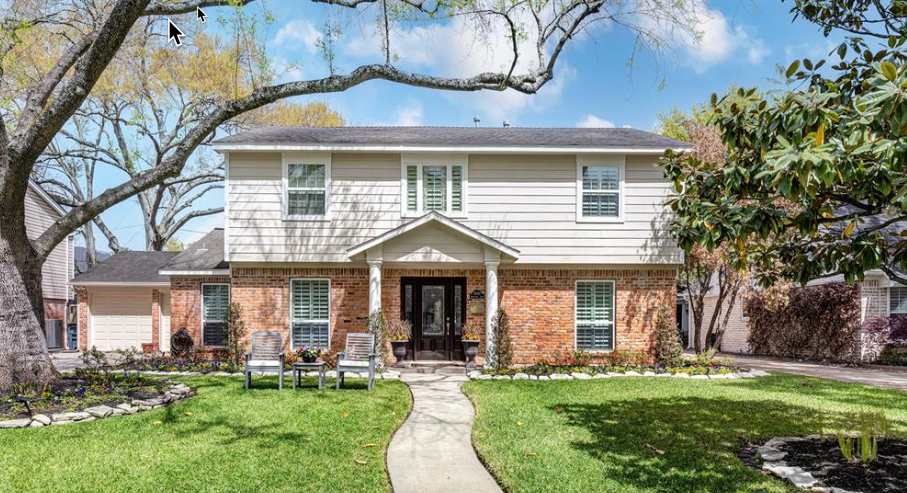 Exterior house painting in Cypress, Texas, featuring light gray siding and crisp white trim.
