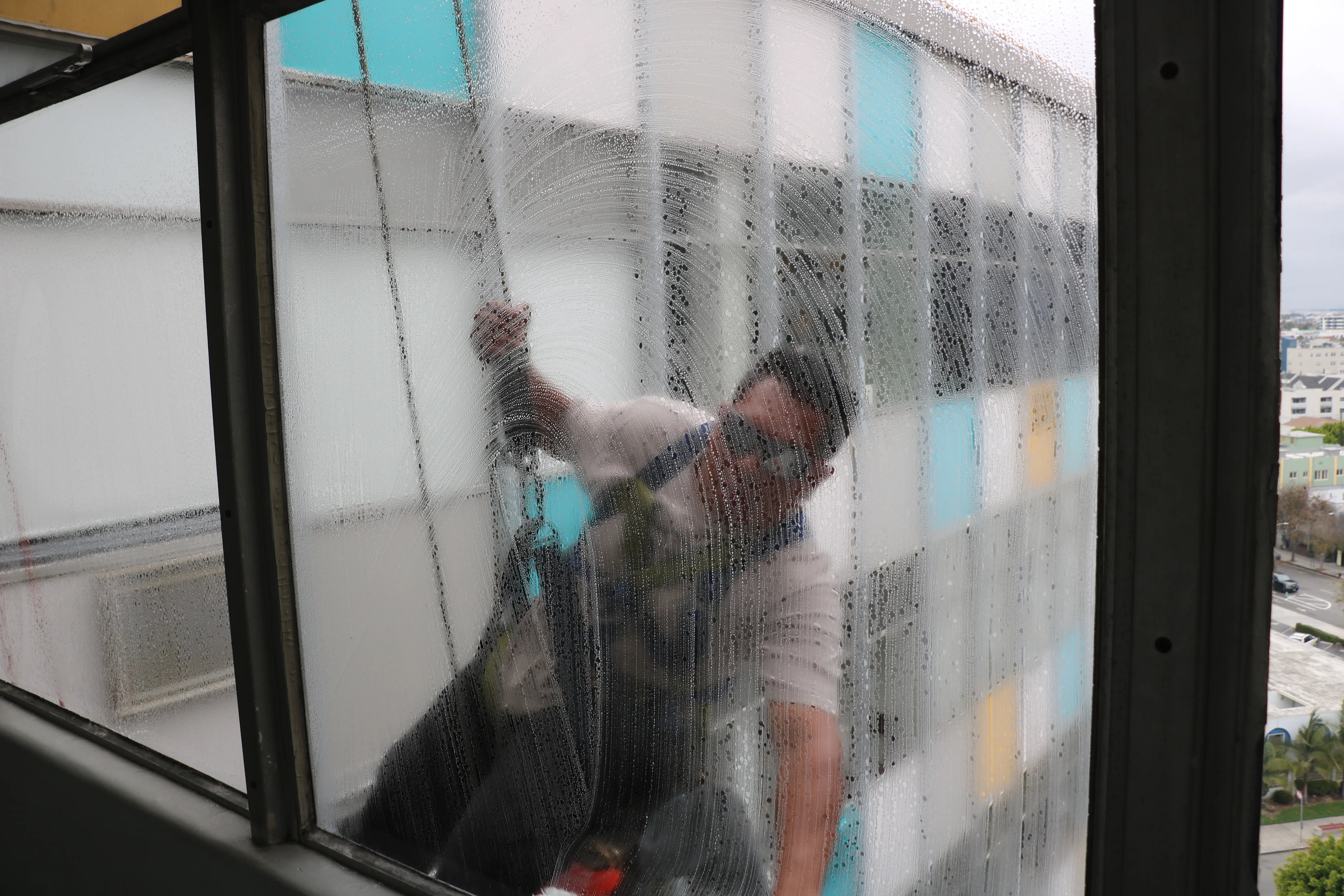 EcoShine technician cleaning exterior windows