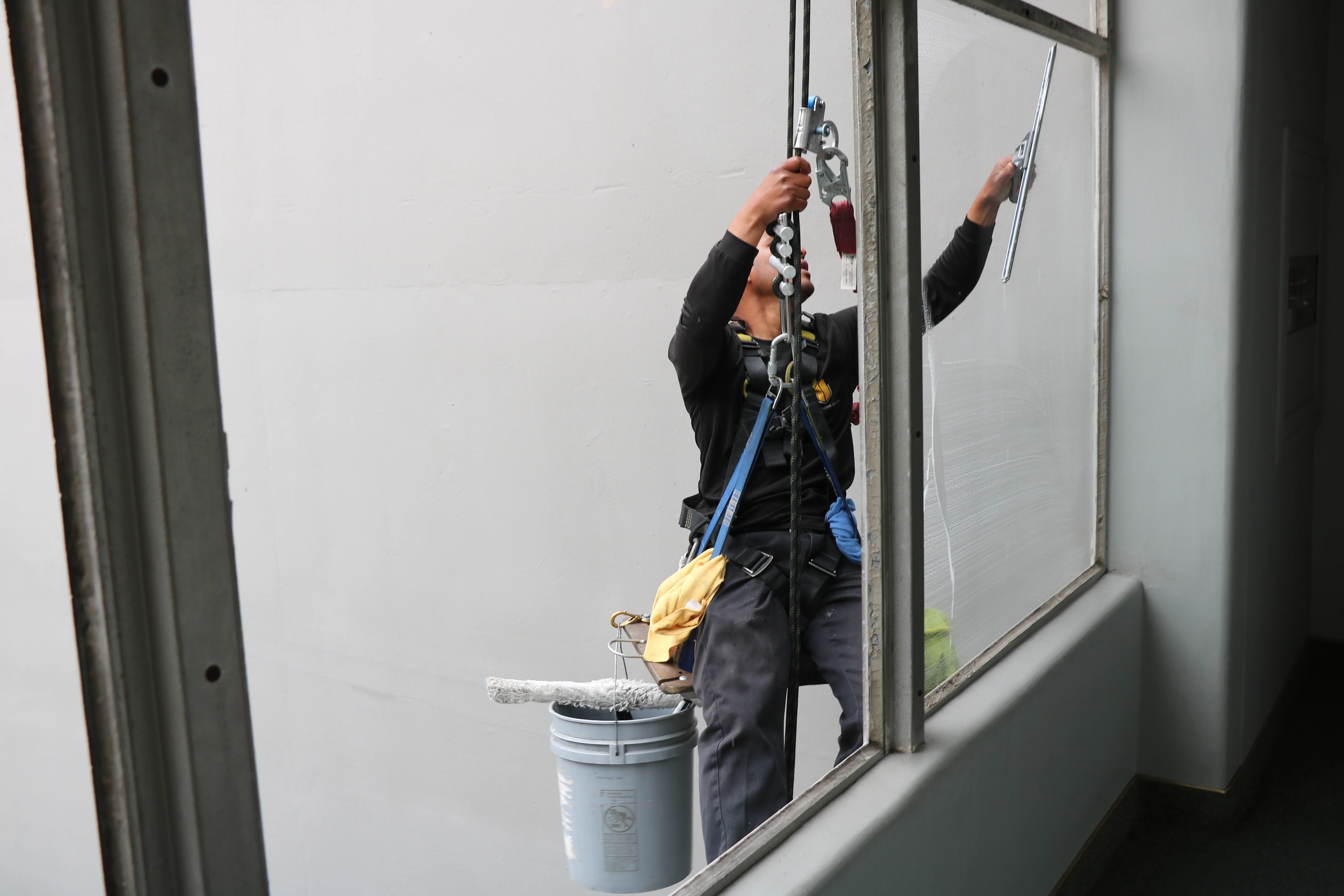 EcoShine technician detailing exterior window glass