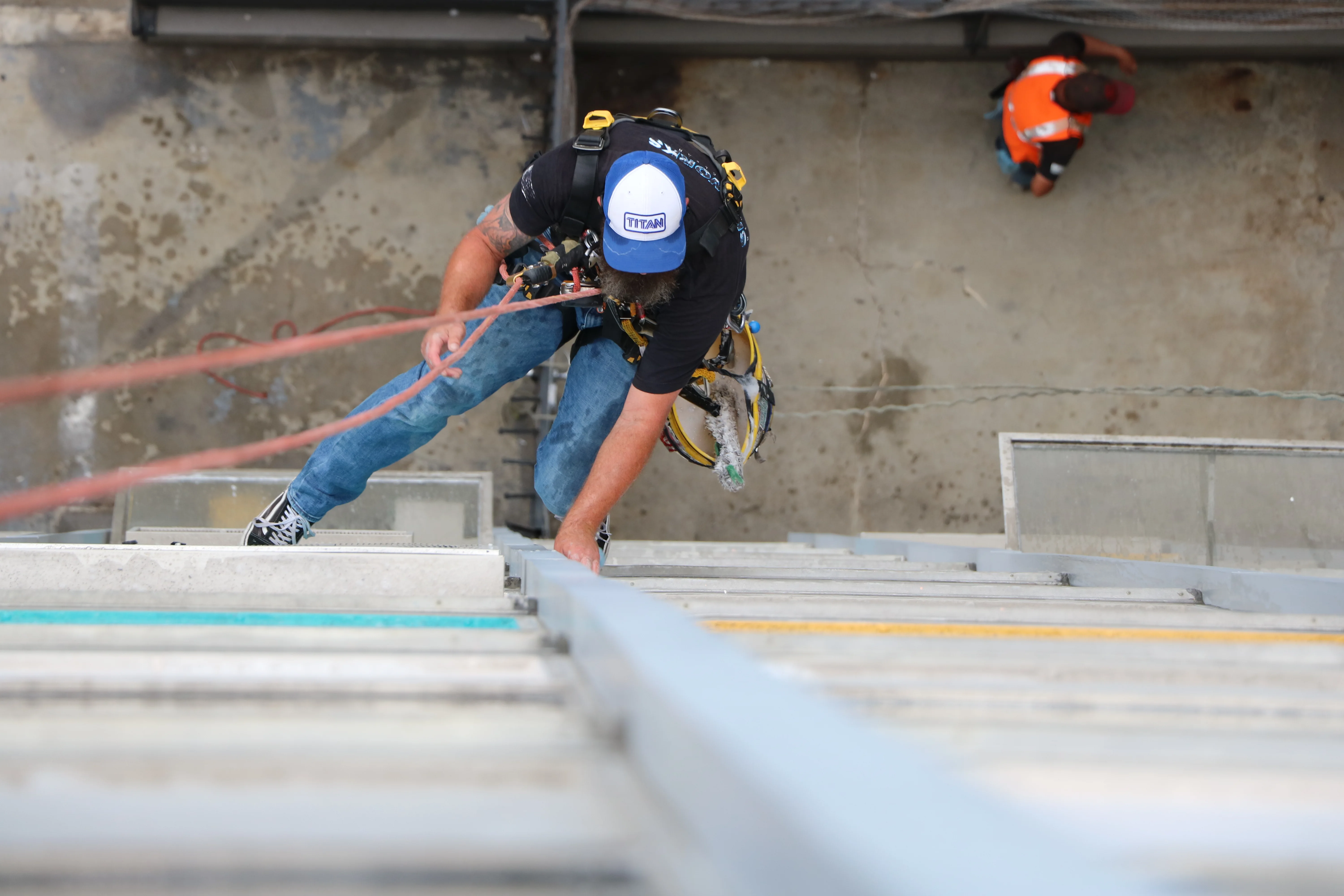 High-access commercial window cleaning technician