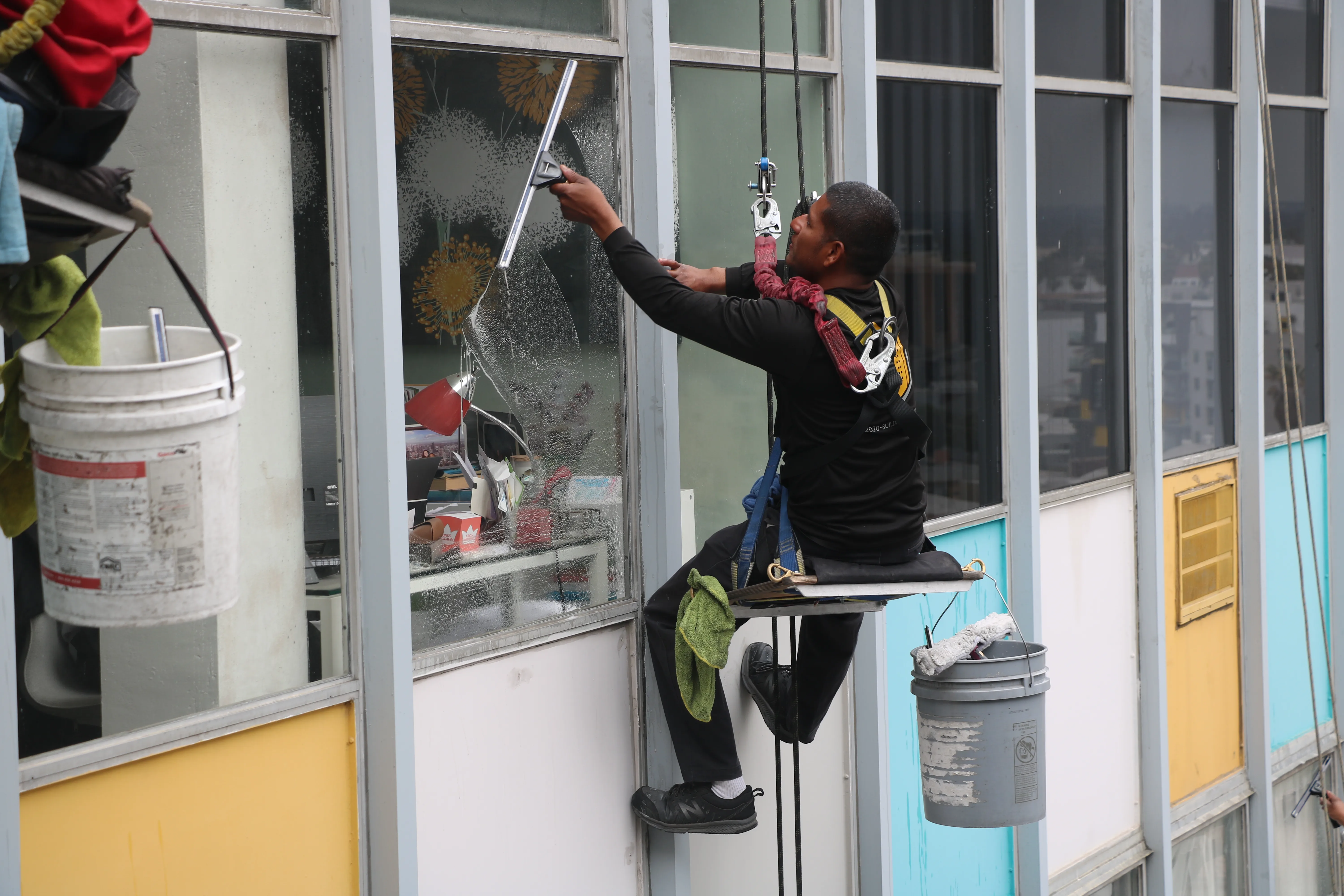 Technician detailing exterior commercial glass
