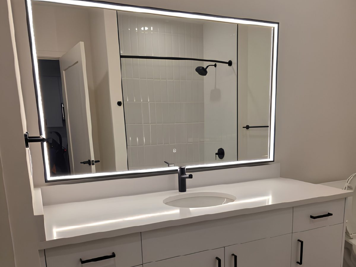 Clean bathroom vanity with a lit mirror