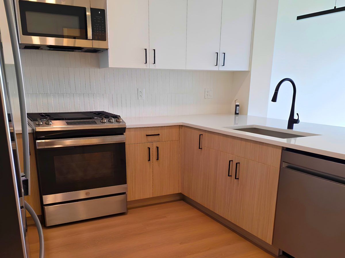 Clean kitchen with wood cabinets and stainless appliances