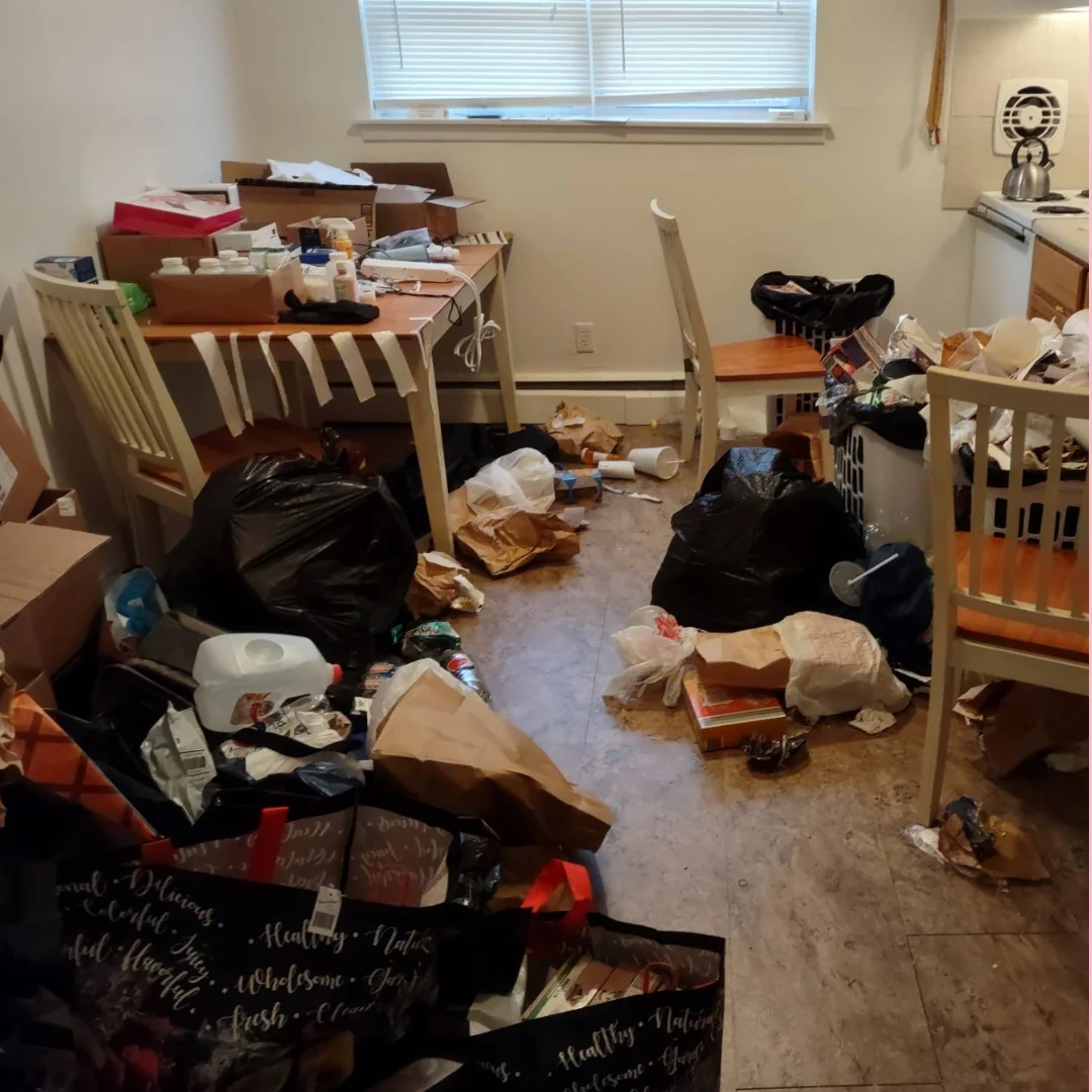 Before: trash bags, boxes and shopping bags covering the kitchen and dining area floor