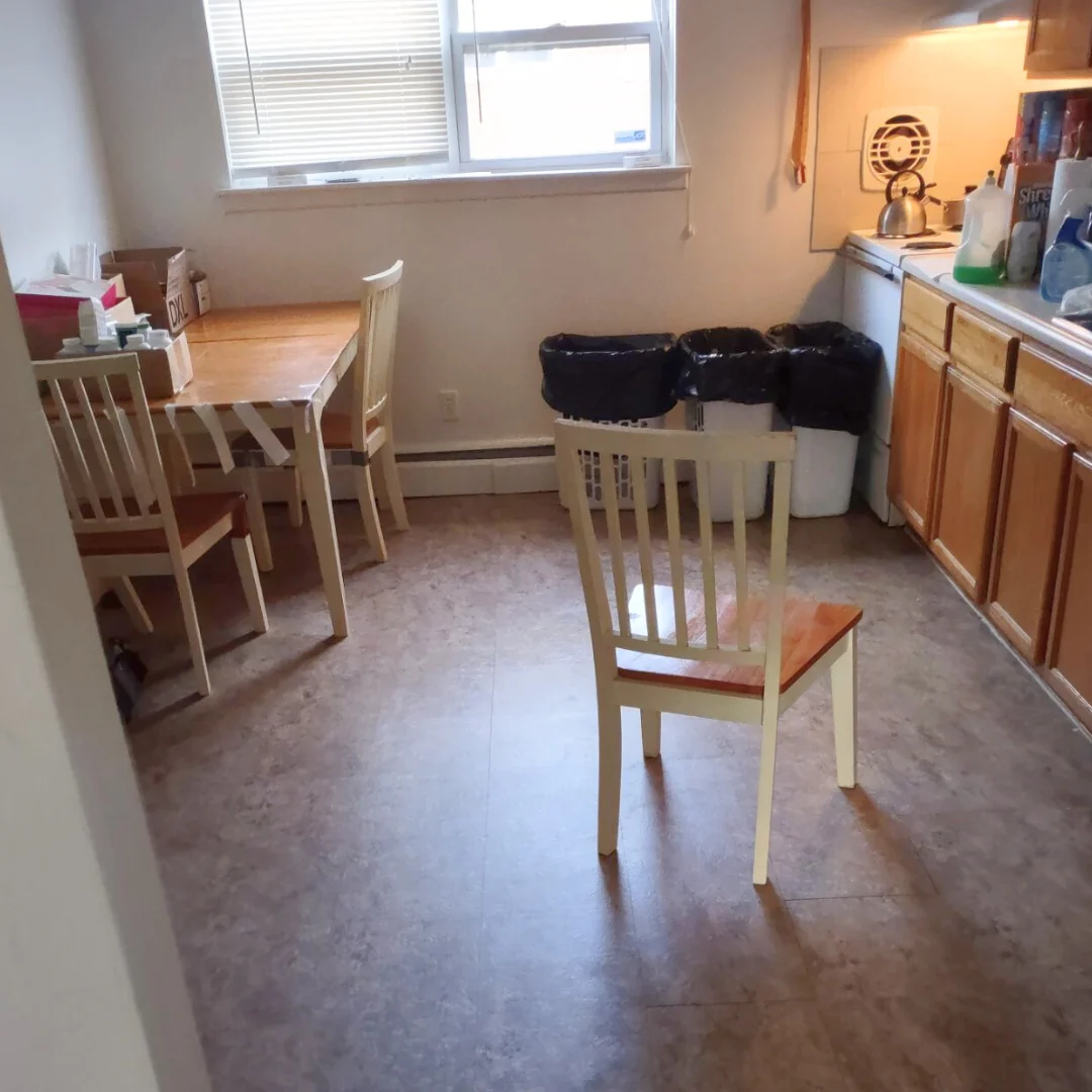 After: the kitchen and dining area with the floor cleared and cleaned and the chairs back in place