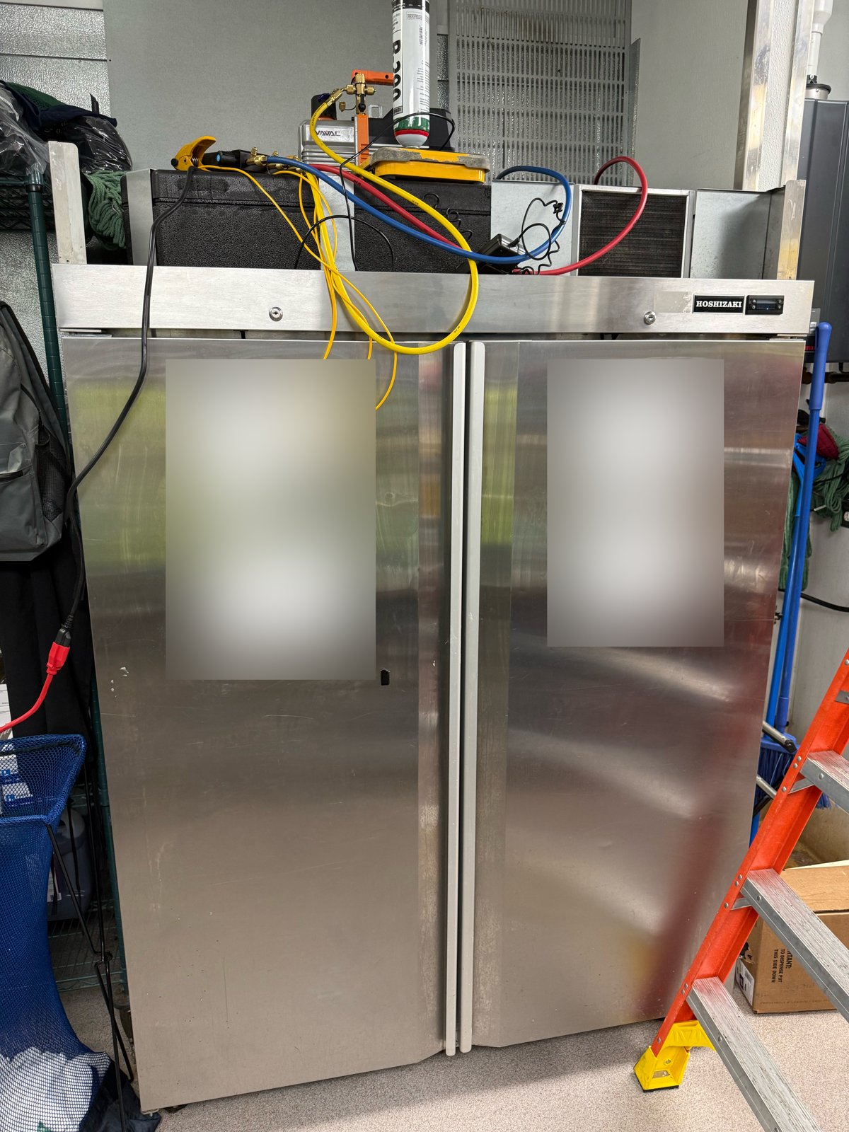 Alliance technician servicing a Hoshizaki reach-in refrigerator