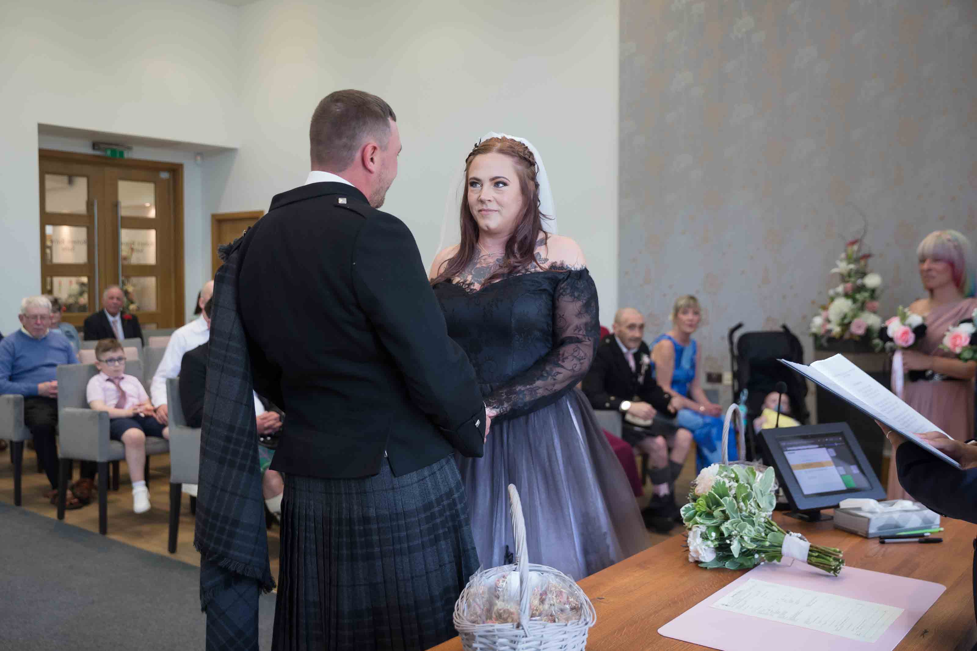 Bride and groom during wedding ceremony at The Burns Monument