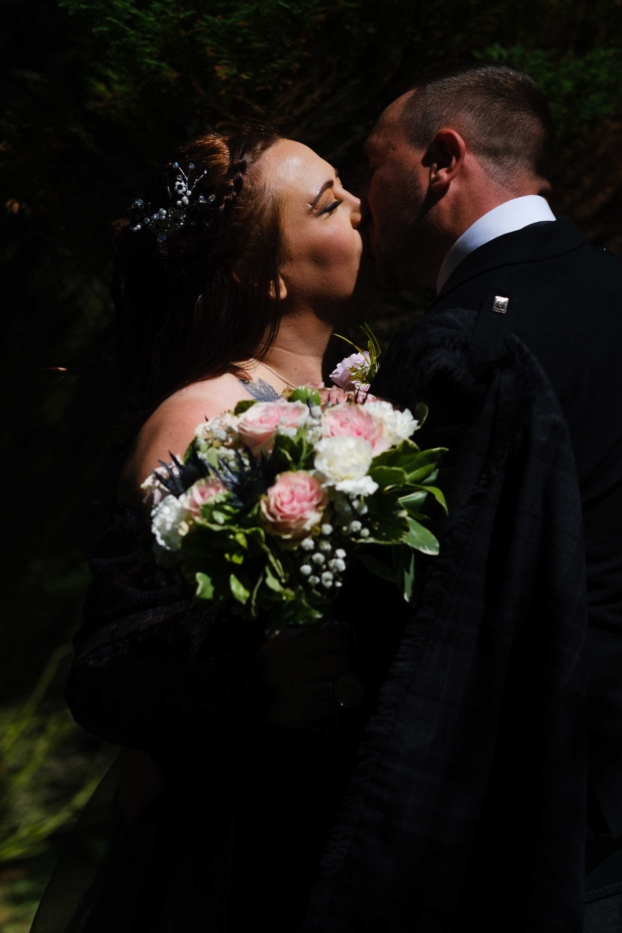 Bride and groom kissing after wedding ceremony, Burns Monument Centre, Kilmarnock