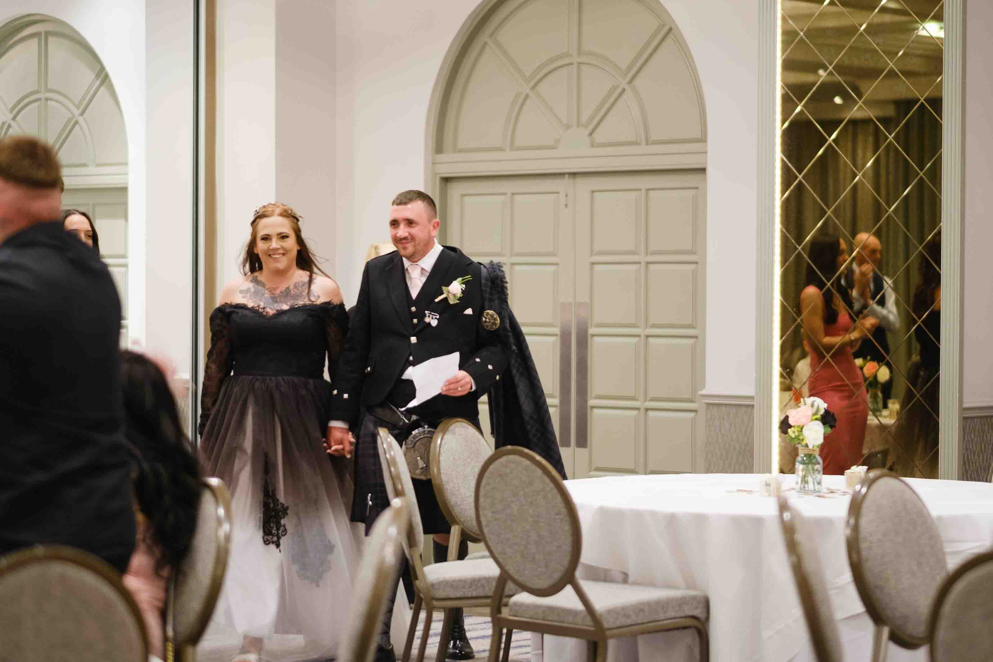 Couple entering thier wedding reception at Dumfries Arms Hotel