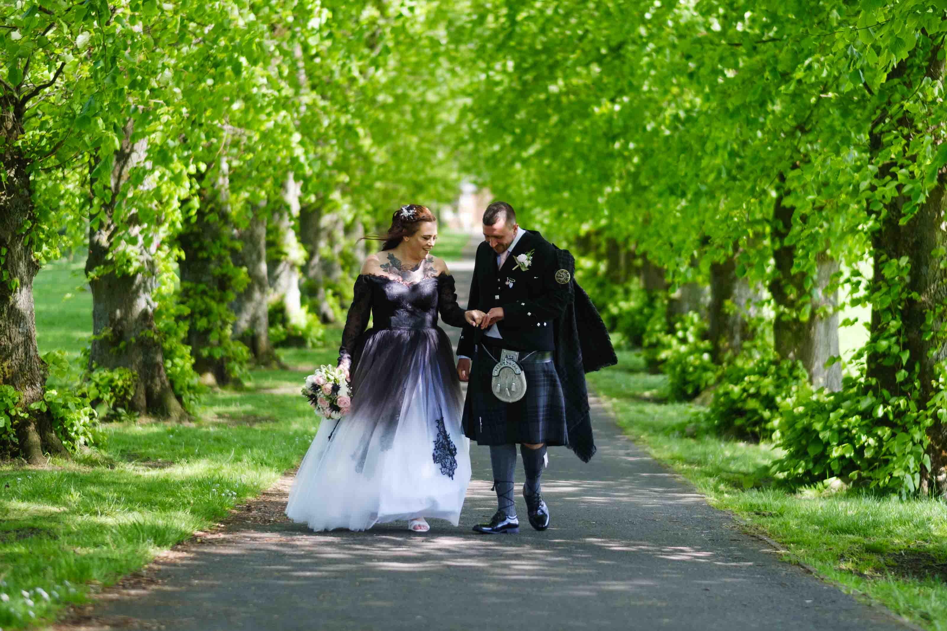 Newly married couple looking at their wedding rings after the ceremony at The Burns Monument Centre