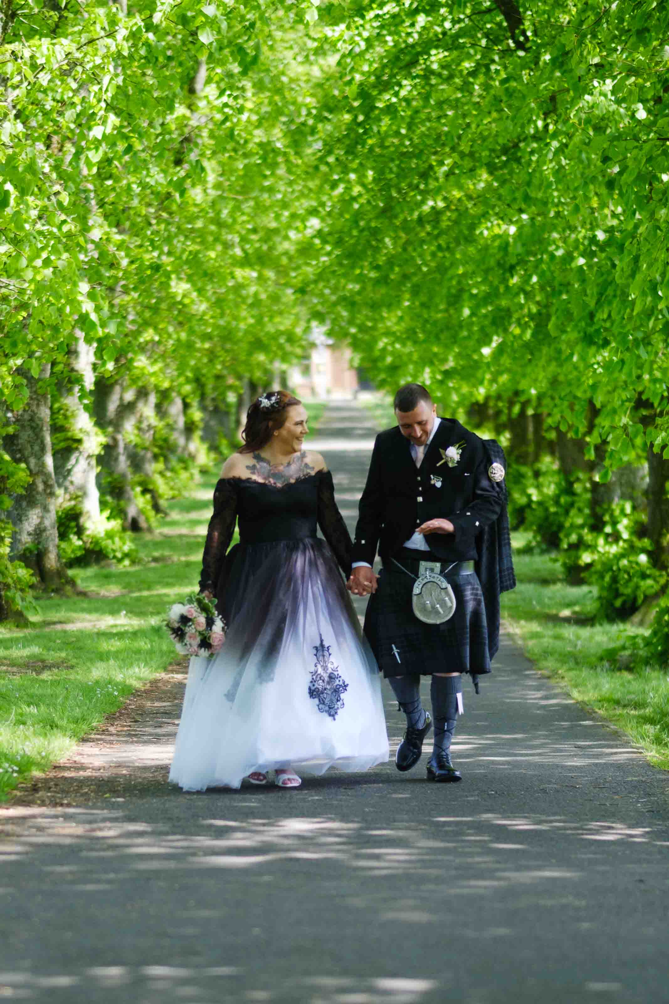Newly married couple looking at their wedding rings after the ceremony at The Burns Monument Centre