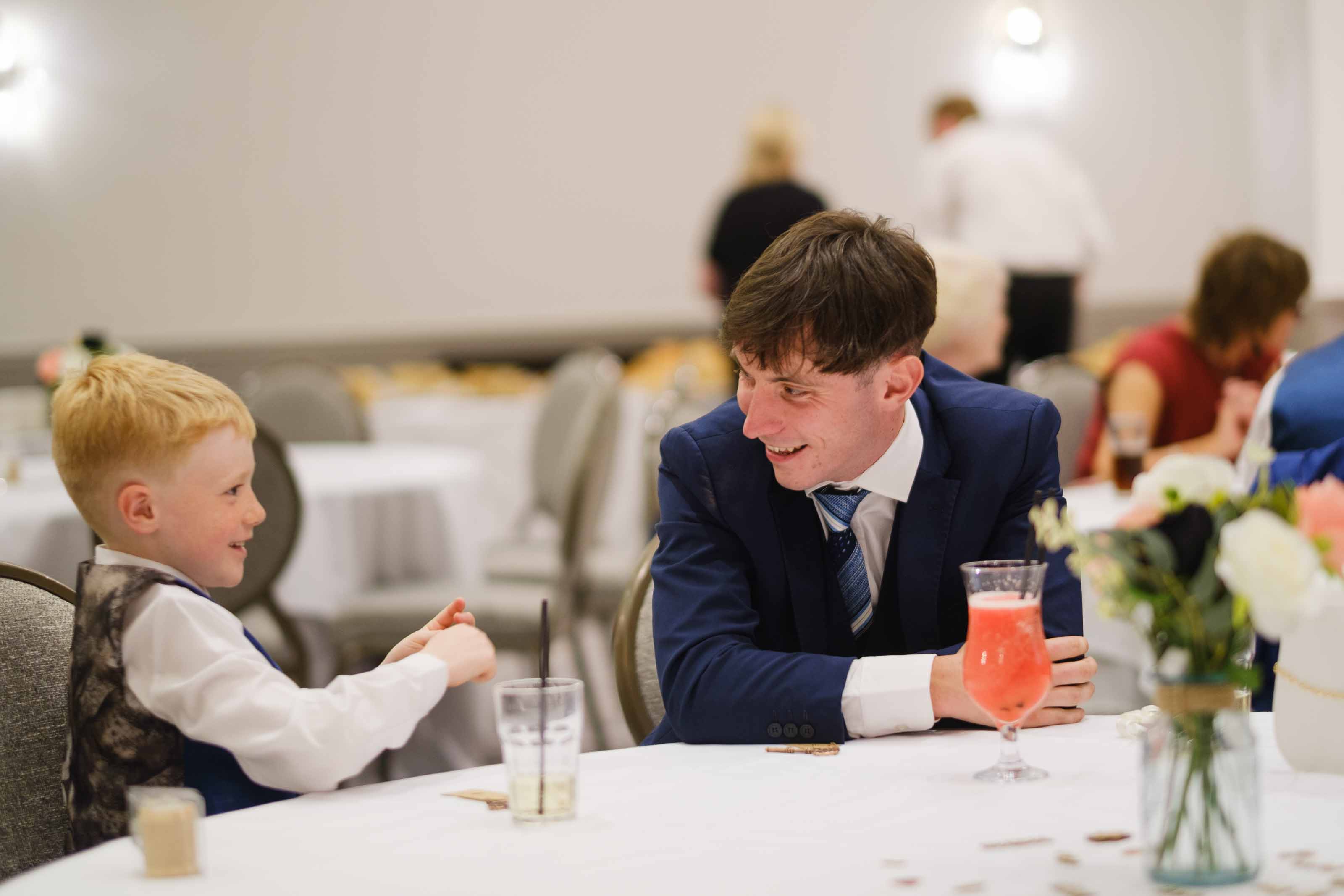 Wedding guest and child playing heads or tails during reception
