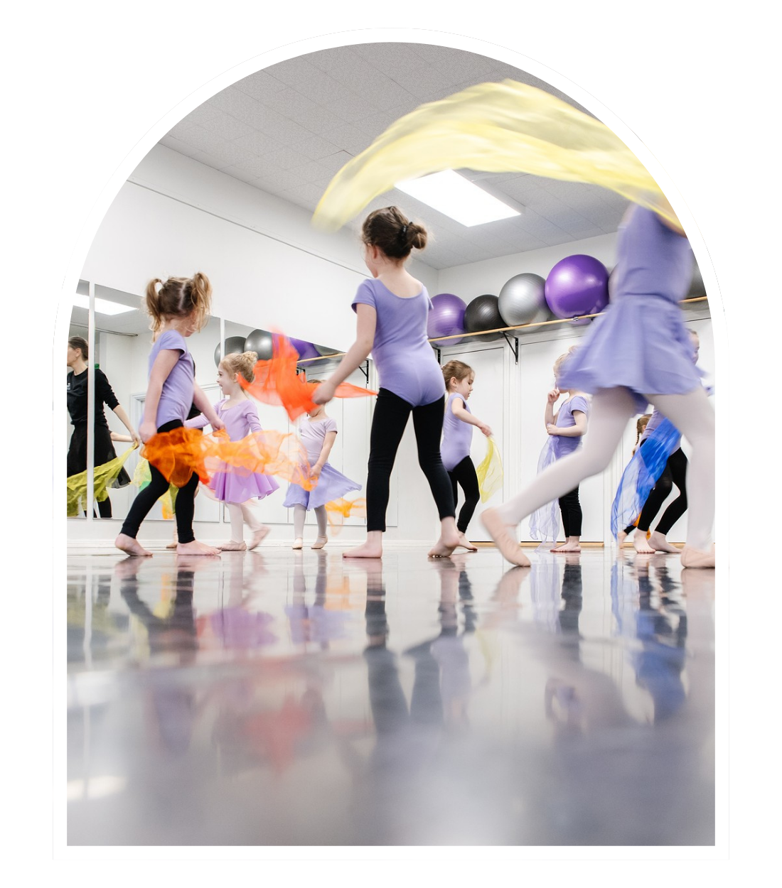 Vintage photo of Pegasus Dance recital - women in green shirt and white skirt leading young children in matching outfits in a dance show