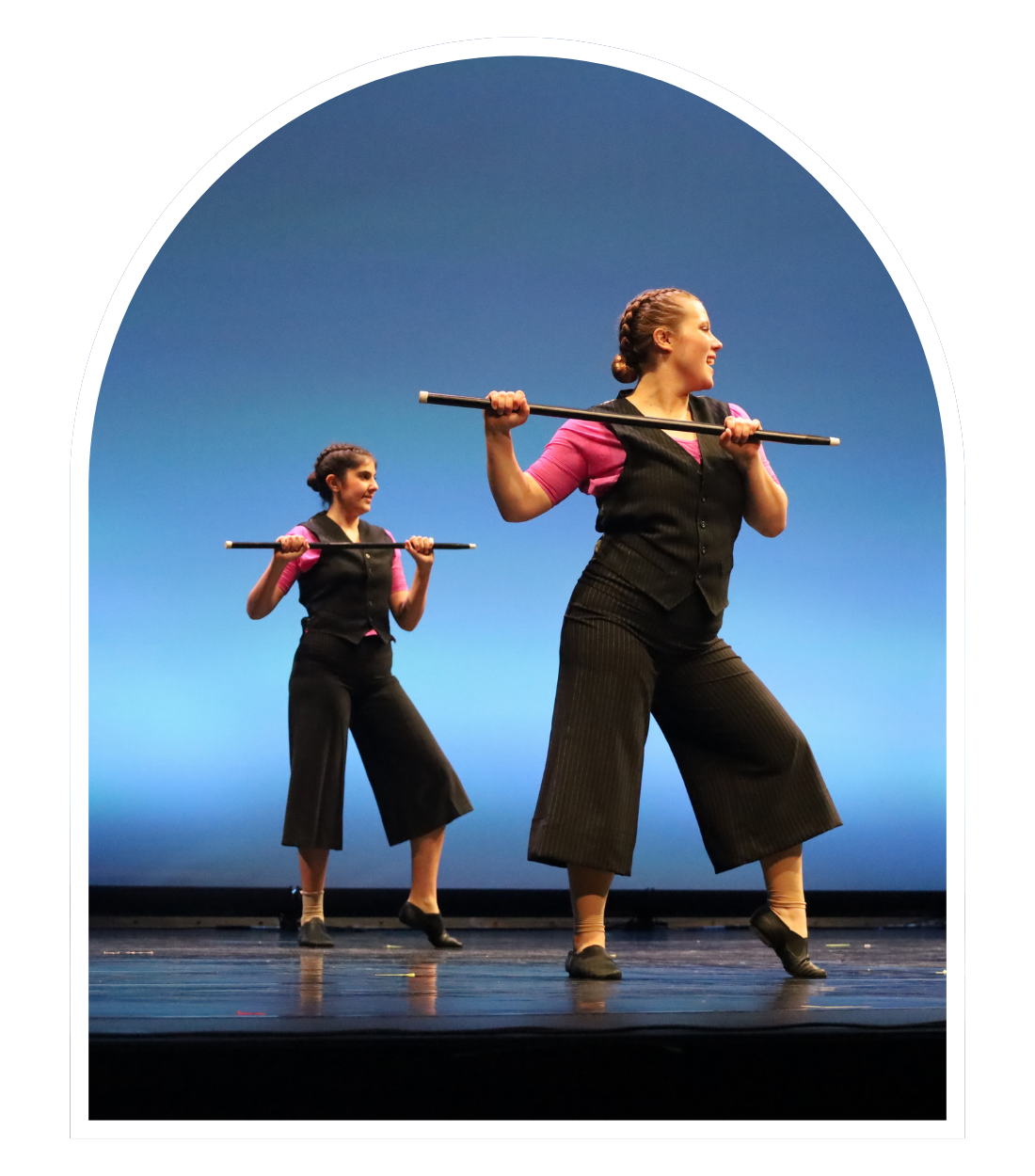 Vintage photo of Pegasus Dance recital - women in green shirt and white skirt leading young children in matching outfits in a dance show