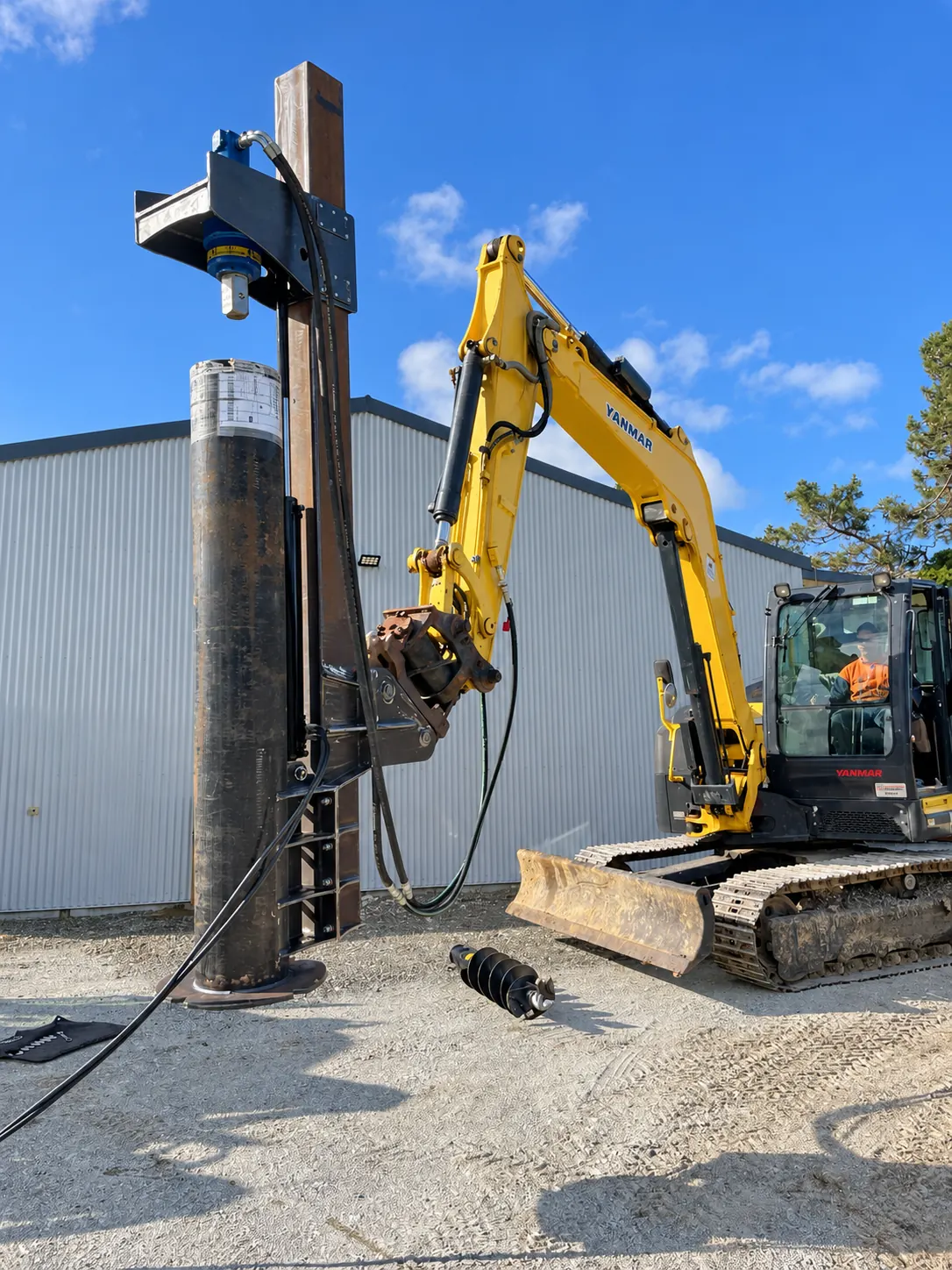 Excavator outside a workshop