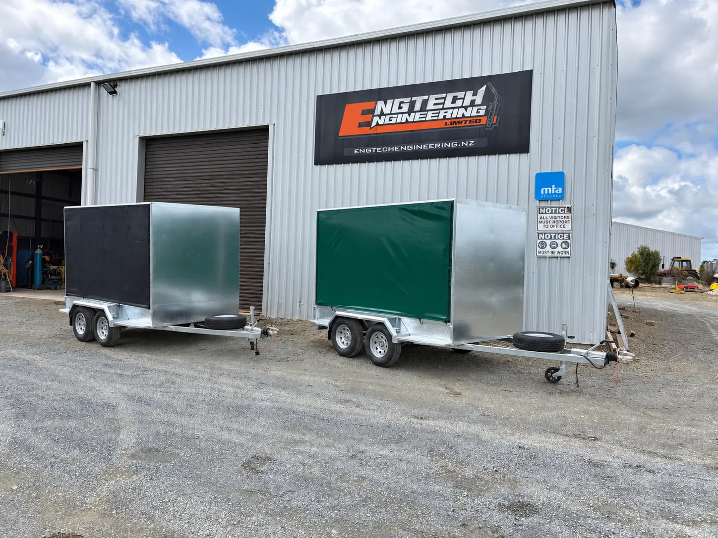 Trailer parked outside a workshop