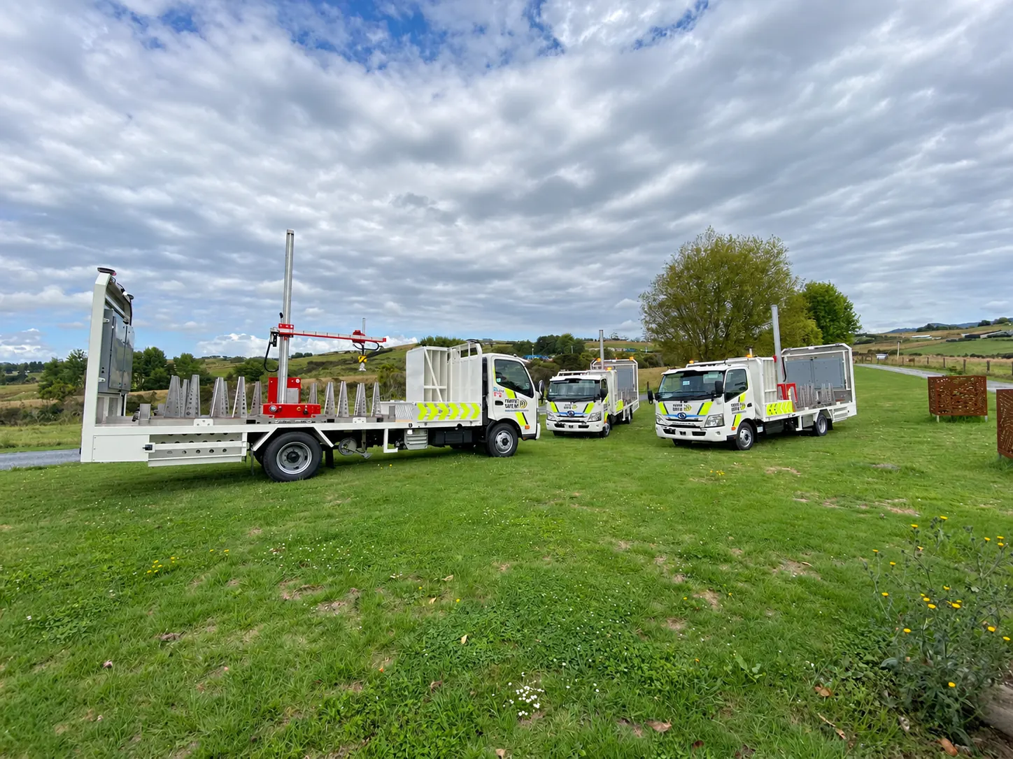 Traffic management trucks and a trailer in a field