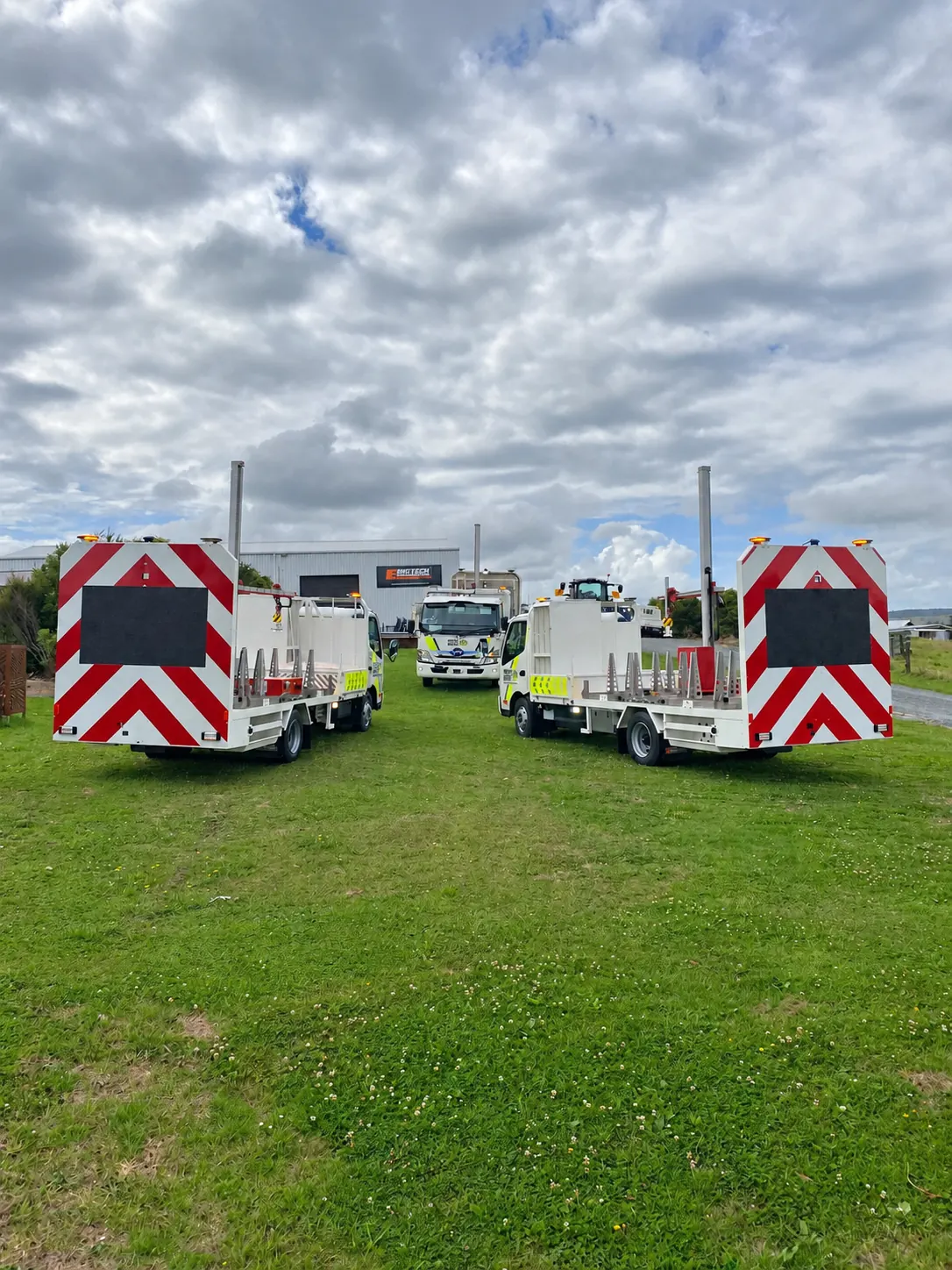 Traffic management trucks parked in a field