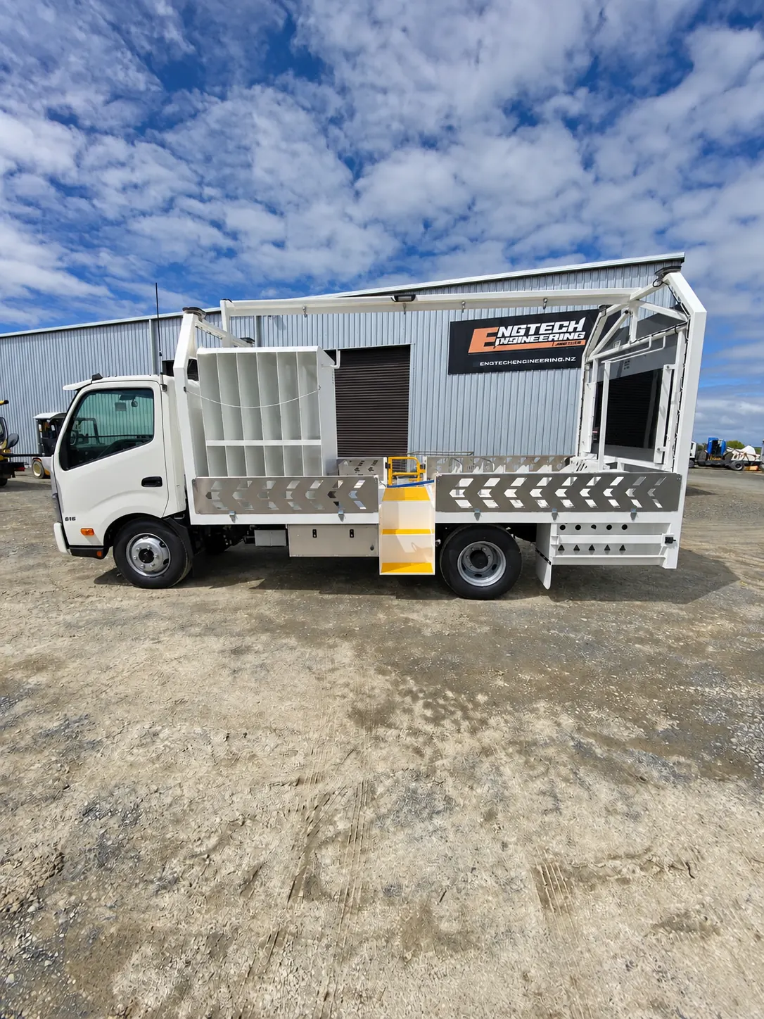 Work truck parked on a gravel yard