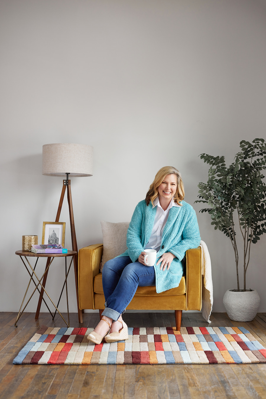 Kristen Chambliss smiling in chair with coffee