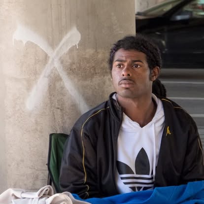 Person experiencing homelessness on city street